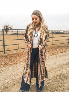 An image of a model wearing The Brazos Ashley Duster, a fashion cardigan from Wesley’s Boutique.